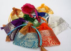 Pretty Organza Jewelry bags, You want to stand out from the crowd give your customers your jewelry pieces in these gorgeous colorful pouches. Not your typical Organza bags, these have a lovely bottom brocade trim. They come in a pack of 100 assorted colors each prettier then the other. They are well made so your customer can keep them to store the item they bought. Each pouch measures 4x4 inches and has a satin cord drawstring. I have other pouches I can source as well , so if you have something Elegant Festival Bags For Gifts, Elegant Festival Bags Suitable For Gifts, Elegant Multicolor Pouch For Festivals, Elegant Festival Gift Bags, Elegant Multicolor Pouch For Festive Occasions, Festive Multicolor Rectangular Pouch, Multicolor Party Gift Bag, Traditional Multicolor Bags As Gifts, Multicolor Pouch Potli Bag For Party