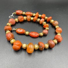 The Rare Unique PEMA RAKA Carnelian Amulet Prayer Beads Necklace From Himalayan Tibet The Age Of This Beads Are More than 1000 years Old As You Can See From Its Conditions Very Oily Smooth Skin Of This Pema Beads Some Gold Plated Wax and Gold Color Brass Beads Are Used As Spacers Rare Items For Collections Traditional Beaded Bracelets With Natural Stones For Healing, Orange Beaded Amulet Jewelry, Traditional Orange Beaded Necklace With Gemstones, Traditional Orange Gemstone Beaded Necklace, Orange Beaded Amulet Necklace, Hand-strung Orange Jewelry With Round Beads, Amber Carnelian Beaded Bracelets With Round Beads, Orange Hand-strung Jewelry With Round Beads, Orange Amulet Beaded Necklace With Large Beads