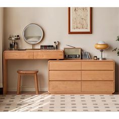 a wooden dresser sitting next to a mirror on top of a white tiled floor in front of a window