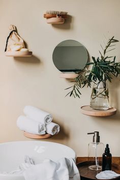 there is a vase with some plants in it and towels on the table next to it