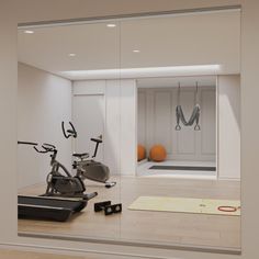 an exercise room with mirrors and bikes in it