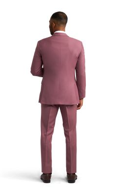 A slim rose pink suit with two buttons and a notch lapel. Pink Double Breasted Suit With Notch Lapel For Work, Pink Double Breasted Notch Lapel Suit For Work, Pink Tailored Double Breasted Suit With Suit Collar, Tailored Pink Double Breasted Suit With Suit Collar, Tailored Pink Double Breasted Suit, Tailored Double Breasted Pink Suit, Elegant Pink Blazer With Welt Pockets, Pink Fitted Double Breasted Suit With Notch Lapel, Tailored Pink Double Breasted Suit For Business