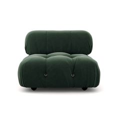 a green couch sitting on top of a white floor