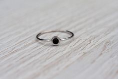 Gorgeous, simple, filigree ring with black gemstone- black onyx handcrafted in 14k white gold. The onyx is a natural gemstone, Earth mined. In the back of the ring secret heart. Makes it perfect gift to celebrate Valentine's day, anniversary, birthday or any other occasion. This ring is made to order in YOUR SIZE. CENTER STONE: *100% natural, AAA quality onyx *round cabochon *color: black *diameter: 3mm APPROXIMATE MEASUREMENTS OF THE RING: *onyx with setting: 4.5mm *band: approximately 1mm *mat Minimalist Black Round Band Ring, Elegant Onyx Rings For Everyday Wear, Minimalist Stackable Black Rings, Minimalist Black Enamel Onyx Ring, Minimalist Onyx Gemstone Ring, Minimalist Onyx Ring With Black Enamel, Black Sterling Silver Stackable Jewelry, Dainty Black Adjustable Rings, Minimalist Black Round Ring