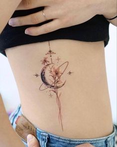 a woman's stomach with a tattoo on it and an image of the moon