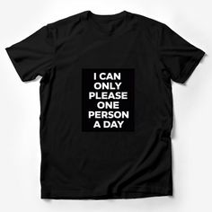 Make a statement with this bold and humorous graphic t-shirt! Perfect for those days when you want to remind everyone that you can only please one person a day. This tee is made with high-quality material for comfort and durability. The black background highlights the white text that playfully says, I CAN ONLY PLEASE ONE PERSON A DAY. It's a unisex fit, ideal for anyone looking to add a touch of sarcasm to their wardrobe or searching for a fun gift for a friend with a sense of humor. Easy to wea Funny Black Slogan Top, Funny Black Tops With Slogan, Funny Slogan Shirt For Streetwear, Funny Black Shirt With Letter Print, Funny Black T-shirt With Graphic Print, Graphic Tee T-shirt With Quote For Streetwear, Graphic Tee With Quote Print For Streetwear, Black Crew Neck T-shirt With Funny Text, Funny Black Slogan Shirt