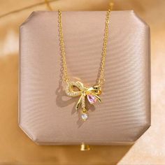 New Beautiful!! Stainless Steel Gold Tone Bow Know Pendant With Cz's Necklace. Necklace Has An Extension On The Clasp. Perfect For Yourself Or As A Gift. Very Unique And Different. Very Shiny And Brilliant!! Suitable For All Occasions. Suitable For Most Ages. Nwt Bow Necklace Gold, Pink Rhinestone Clavicle Chain Necklace, Pink Rhinestone Necklace For Valentine's Day, Pink Clavicle Chain Rhinestone Necklace, Rose Gold Rhinestone Necklace For Gift, Rose Gold Rhinestone Necklace Gift, Rose Gold Cubic Zirconia Rhinestone Necklace Gift, Pink Cubic Zirconia Clavicle Necklace, Elegant Pink Clavicle Chain Necklace