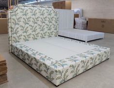 a bed that is in the middle of some boxes