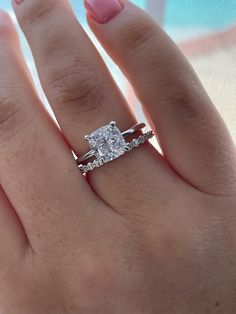 a woman's hand with a diamond ring on it