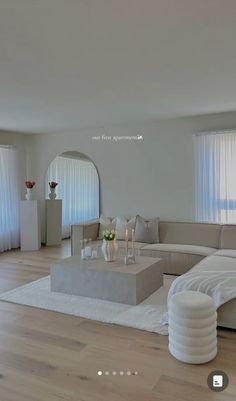 a modern living room with white furniture and large windows in the backround area