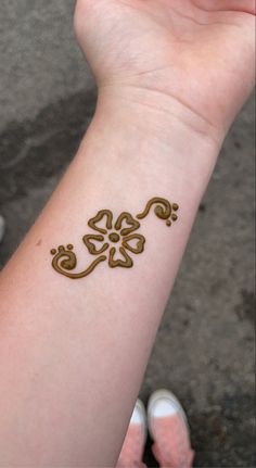 a woman's arm with a tattoo on it that looks like a lizard and flowers