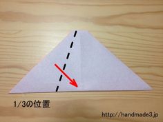 an origami paper airplane with a red arrow on it