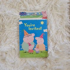 a children's book about pep the pig and his friends is laying on a fluffy white blanket