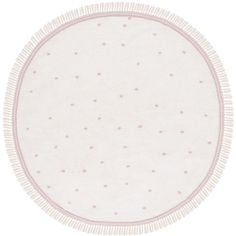 a round rug with white and pink dots on the bottom, in front of a white background