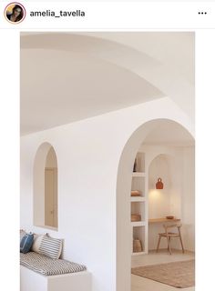 the interior of an apartment with white walls and arches