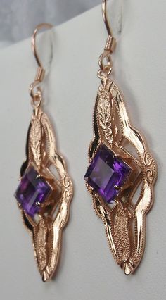 "Natural Amethyst Earrings Star Design#E6 Custom Made These are Victorian era reproduction earrings (Made from and Antique brooch) in sterling silver set with flawless high quality natural purple amethyst gemstones. Each stunning 1ct Amethyst is 6mm long/wide (1/4th\"). The earrings are 1 3/4th inches long and 14mm (1/2\") at its widest point. Notice the beautiful leaf on the bottom and top of the setting. These lovely earrings were fashioned from an antique Victorian floral brooch. A gift box i Ornate Purple Drop Earrings, Elegant Purple Jewelry With Ear Wire, Ornate Purple Jewelry With Matching Earrings, Ornate Purple Dangle Jewelry, Ornate Purple Pierced Earrings, Purple Earrings With Intricate Design For Gift, Purple Earrings With Intricate Design As Gift, Purple Nickel-free Jewelry For Formal Occasions, Elegant Purple Pierced Jewelry