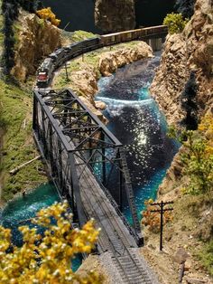 a train traveling over a bridge next to a river