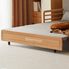 a bed with a wooden frame and mattress on it's side in a bedroom