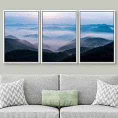 three canvases hanging on the wall above a couch in front of a gray sofa