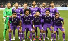 a group of soccer players pose for a team photo