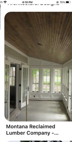 the inside of a house with windows and wood paneling on the ceiling is shown