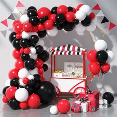 the balloon arch is decorated with black, white and red balloons