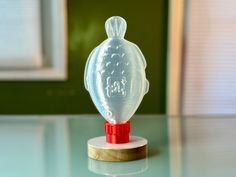 a clear glass figurine sitting on top of a table