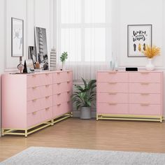 two pink dressers with gold handles in a white living room, one has a plant and the other is a potted houseplant