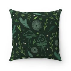 a green pillow with mushrooms and leaves on it