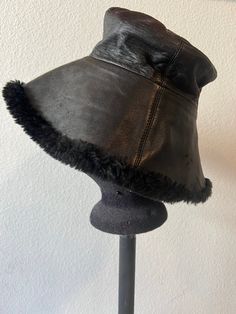 Vintage 90's black fur very soft leather shearling bucket hat by Gilly Forge London. Condition: good vintage condition Winter Black Sheepskin Hats, Vintage Leather Hats For Winter, Vintage Leather Winter Hats, Vintage Black Bucket Hat With Curved Brim, Black Faux Fur Hat With Faux Fur Trim, Vintage Black Bucket Hat, Vintage Black Wide Brim Bucket Hat, Black Leather Hat With High Crown, Black Leather Vintage Hat