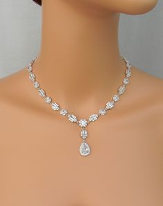 "Brilliant and full of sparkle! This necklace is decadent. The pictures do not do it justice! Sleek and elegant, this necklace truly make a statement! The quality of my pieces are second to none. I use high quality Pure Brilliance crystals. Matching Julienne pieces: https://www.etsy.com/shop/CrystalCorridor?search_query=julienne Matching bracelet sold separately: https://www.etsy.com/listing/250443255/rosegold-bridal-bracelet-crystal-wedding I've designed the Julienne full crystal necklace to cr Wedding Costume Jewelry Teardrop, Elegant Jeweled Drop Necklace For Wedding, Elegant Dangle Diamond Necklace For Wedding, Sparkling Dangle Necklaces For Wedding, Elegant Sparkle Necklace For Anniversary, Gold Pear-shaped Diamond Necklace For Wedding, Sparkling Dangle Necklace For Wedding, Wedding Costume Jewelry Necklaces With Sparkling Stones, Gold Drop Diamond Necklace For Wedding