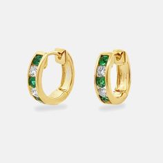 Our emerald and diamond channel set huggies are stunning hoop earrings featuring an alluring mix of green emeralds and diamonds. They give you a touch of bold color and timeless beauty. This piece really pops when paired with other emeralds from our Gemstone Collection. Natural Sapphires: 0.25ctw Natural Diamonds: 0.20ctw 18K Yellow Gold Length: 1/2 Inch Elegant Green Huggie Jewelry, Fine Jewelry With Channel Set Green Stones, Fine Jewelry Green Channel Set, Emerald Huggie Earrings For Anniversary, Fine Green Jewelry With Channel Set, Green Channel Set Fine Jewelry, Yellow Gold Emerald Hoop Earrings Fine Jewelry, Elegant Emerald Huggie Earrings For May Birthstone, Green Diamond Hoop Earrings Fine Jewelry