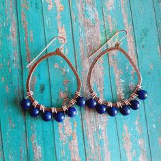 "Lapis Lazuli Gemstone Copper Hoop wire wrapped Dangle Earrings These Lapis Lazuli Earrings are  light weight and comfortable. Put them on with a pair of jeans and a white T and they will jazz up your style. They can also be worn with various earth tone colors if you are going for a rustic look Length: 2\" COMES IN A GIFT BOX" Blue Bohemian Teardrop Earrings With Wire Wrapped, Blue Wire Wrapped Bohemian Teardrop Earrings, Bohemian Blue Wire Wrapped Teardrop Earrings, Lapis Lazuli Earrings, Hippy Gifts, Earth Tone Colors, Earrings Teardrop, Lapis Lazuli Gemstone, Jewelry Earrings Hoops