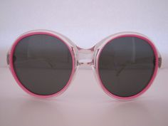 A great store basement find Condition: UNUSED (old store stock) A MOD classic vintage pair of sunglasses Made in Italy (1960) Maker Unknown Made of plastic, metal and glass Has original smoke glass lenses which absorb ultra violet and infra rays of the sun The round shape frame has a two-tone color feature Main colors: transparent clear and pink Temples are attached to the frame with a 3 barrel metal hinge Metal hinges are pinned to the front of the frame and to the sides of the temple Temple ma Italian Sunglasses, Toy Watch, Rays Of The Sun, Metal Hinges, Drip Painting, Display Cards, The Temple, Sunglass Frames, Classic Vintage