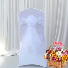 a white chair with a flower basket next to it