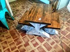 a wooden table sitting on top of a tiled floor