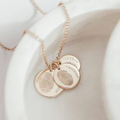 Capture and enhance the beautiful detail of fingerprints with our stunning multi charm necklace. The lines and grooves that make a fingerprint unique are lasered on to sterling silver discs and hung on an elegant silver link chain to create a very special piece of jewellery.  A name is engraved next to each print. Chose up to three charms in descending sizes. When lasering your charms we will laser the largest with the eldest child and smallest with the youngest. Perfect for preserving children's prints and an ideal choice for a family keepsake. Comes in Gold or Sterling Silver Taking the prints is fun and easy to do and we will provide full instructions. We will take the most detailed or interesting section of the prints you supply and enhance them to fit the shape required * * * How we g Sterling Silver Etched Round Disc Necklace, Elegant Etched Round Disc Necklace, Elegant Hand Stamped Necklace Keepsake, Elegant Hand Stamped Keepsake Necklaces, Elegant Hand Stamped Necklace For Keepsake, Elegant Stamped Round Disc Jewelry, Elegant Hand Stamped Keepsake Necklace, Fingerprint Necklace, Gold Gift Boxes