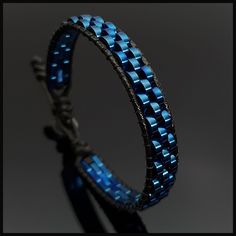 This handmade stylish blue hematite  bracelet will perfectly fit with your formal style. It is a perfect gift for you and all your loved one for all special days such as birthday, valentine's day, father's day, anniversary etc. Wrap is durable 1,5 mm polyester black rope. For closure of our high quality bracelet we used zamak alloys button with 2 optional closure buttonhole. Please kindly check your wrist size according to the picture of measurement instruction and order the same size.  All our designs prepare by hand according to the your given sizes with love. We offer 8 size option between 5.9-8.7 inches (15-22 cm) , please DM us to demand different wrist size. Used materials; 2*6 mm two hole pig nose bluehematite 1.5 mm black korean rope 1 cm zamak alloys button ☆ABOUT US☆ https://www. Elegant Blue Wrap Bracelet As A Gift, Elegant Blue Wrap Bracelet As Gift, Elegant Adjustable Blue Leather Bracelet, Elegant Blue Adjustable Leather Bracelet, Modern Blue Adjustable Bracelets, Modern Adjustable Blue Bracelets, Modern Blue Beaded Bracelets For Gift, Modern Blue Beaded Bracelets As Gift, Adjustable Hand Wrapped Blue Leather Bracelet