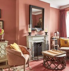 a living room filled with furniture and a fire place in front of a mirror on the wall