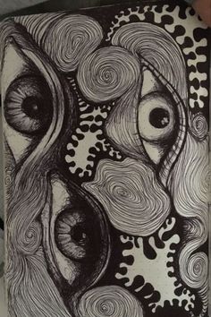 a black and white drawing of an eye with swirls on the outside of it