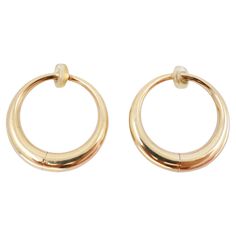 Crafted in the the 1990s, these vintage 14k gold hoop earrings exude elegance. With a weight of 8.9 grams, and a classic hoop design, these earrings boast a length and width of 1.13 inches, making them both statement-making and versatile. Designed as clip-ons, they offer effortless wearability for pierced and non-pierced ears alike. Whether paired with casual attire or formal ensembles, these earrings are sure to add a touch of vintage glamour to any look, making them a coveted addition to any j 14k Gold Hoop Earrings, Hoop Design, The 1990s, Vintage Glamour, Casual Attire, Jewelry Earrings Hoops, Vintage Yellow, Gold Hoop, Pierced Ears