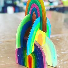 a colorful wooden sculpture sitting on top of a table