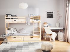 a bedroom with two bunk beds and a desk