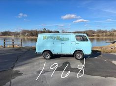 a blue van parked in front of a lake with the words merry marine on it