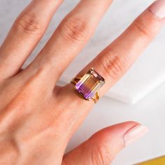 Vintage estate solid 14k gold engagement statement ring featuring a large, genuine Ametrine (Amethyst and Citrine) emerald cut stone. Very beautiful and unique stone with deep purple and yellow colors. Weight: 4.41 grams Ring size: 4.75(US) Ring Band Width: 3.5mm (widest part) Gemstone Measurements: 14x10mm Hallmarks: N/A. We guarantee to have tested this ring to be 14k. Your item will arrive in a jewelry box ready to be gifted. All merchandise in my shop is in good, pre-loved condition. Please Citrine And Amethyst Ring, Luxury Multi-stone Amethyst Ring In Yellow Gold, Ametrine Ring, Emerald Cut Ring, Amethyst And Citrine, Yellow Ring, Vintage Sterling Silver Jewelry, Yellow Rings, Emerald Cut Rings