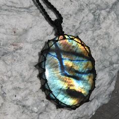 Beautiful handmade Macrame rainbow Labradorite pendant, with an adjustable black necklace cord. The magical Labradorite is believed to protect against the negativity and misfortunes of this world and enhances spiritual growth, intuition, and awareness. This necklace is the perfect meaningful gift for your loved one or yourself! ►►This is a one-of-a-kind necklace, you will receive EXACTLY the one seen in the photos! *'¨) ¸.*'¸.**'¨) ¸. (¸.*' (¸.*` ♥ *FREE INTERNATIONAL SHIPPING ►►Pendant size: St Black Labradorite Jewelry For Gift, Handmade Black Magical Jewelry, Handmade Magical Black Jewelry, Black Labradorite Spiritual Necklaces, Rainbow Festival Jewelry With Adjustable Cord, Rainbow Jewelry With Adjustable Cord For Festivals, Rainbow Adjustable Cord Jewelry For Festivals, Magical Adjustable Pendant Necklace, Magical Black Pendant Necklace