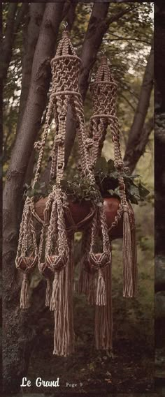 an old fashioned hanging planter in the shape of a horse with tassels attached to it