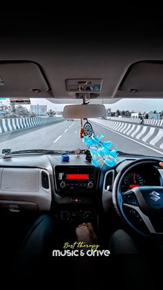 the dashboard of a car with an electronic device on it's dash board and steering wheel