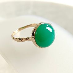 TEM DESCRIPTION: >> The Ring is made from Solid 14K Yellow Gold. Gemstone used is absolutely natural and ethically sourced.  >> Natural Chrysoprase in cabhachon cut and round shape with bezel setting is studded on it with utmost precision.  >>Gem: Chrysoprase Gem size: 12×12 mm, round Gem weight: 7.40 carats Gold purity: 14K (58.33% approx.) Gold weight: 1.52 grams Gross weight : 3.00 grams The Gold purity is guaranteed and it comes with authentic 14K gold hallmark. Since these Rings are handmad Yellow Gold Emerald Chrysoprase Cabochon Ring, Heirloom Style Green Emerald Ring With Polished Finish, Heirloom Style Polished Emerald Ring, Yellow Gold Chrysoprase Cabochon Ring, Yellow Gold Rings With Chrysoprase Gemstone, Chrysoprase Emerald Ring In Fine Jewelry Style, Green Cabochon Rings Fine Jewelry, Green Cabochon Fine Jewelry Rings, Heirloom Green Opal Ring