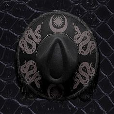 *this item is made by hand each time so placement and print might differ slightly. And a minimal amount of adhesive might show. Also hat band might differ based upon availability. One size fits most with black fringe. I added all items myself by hand and matte black snakes, moons, and sun designs to the top of the brim. Adjustable Flat Brim Halloween Hat, Adjustable Flat Brim Halloween Costume Hat, Adjustable Flat Brim Hat For Halloween, Western Flat Brim Halloween Hat, Western Style Flat Brim Halloween Hat, Western Flat Brim Hat For Halloween, Black Flat Brim Hat Bands For Halloween, Black Halloween Festival Hat Bands, Adjustable Wide Brim Halloween Fedora